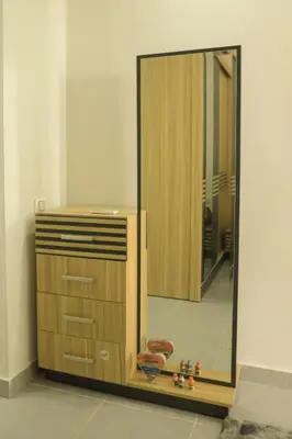 a wooden dresser with a mirror next to a dresser at Angeli Apartment Scandic Rezort in Hurghada