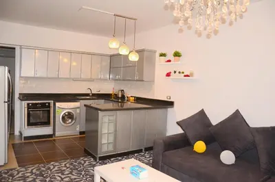 a living room with a couch and a kitchen at GoEgypt Dreams in Hurghada