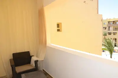 a chair sitting in a room with a window at GoEgypt Dreams in Hurghada