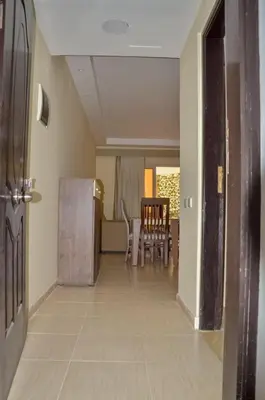an empty hallway with a kitchen and a dining room at Kinga Apartment Florenza Khamsin in Hurghada