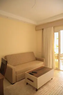 a living room with a couch and a coffee table at Kinga Apartment Florenza Khamsin in Hurghada