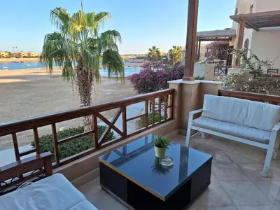 a balcony with a view of the beach at Bella Sabina, Lovely one bedroom chalet with pool in Hurghada