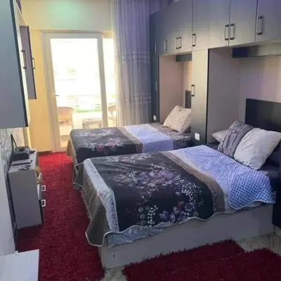 a hotel room with two beds and a window at Lovely APT Sunny Beach Front, Near Senzo Mall Free WIFI in Hurghada