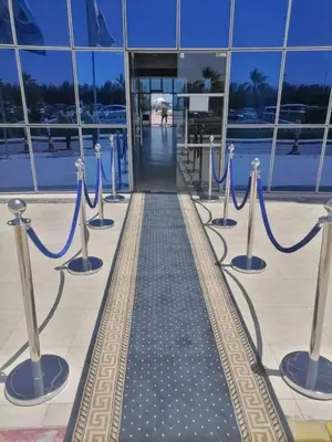 a row of blue rope barriers in front of a building at Lovely APT Sunny Beach Front, Near Senzo Mall Free WIFI in Hurghada