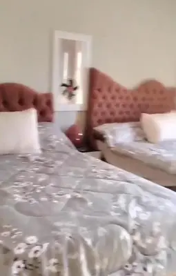 a bedroom with a white bed and a couch at شالية بقرية الذهبية in Hurghada
