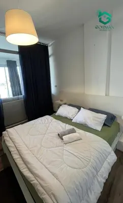 a large white bed in a room with a lamp at Sholan, 1 Bedroom, Ground floor in Hurghada