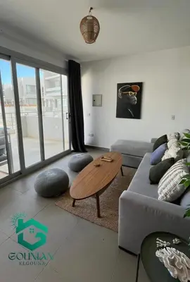 a living room with a couch and a table at Sholan, 1 Bedroom, Ground floor in Hurghada