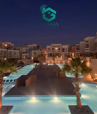 a resort with a swimming pool at night at Sholan, 1 Bedroom, Ground floor in Hurghada