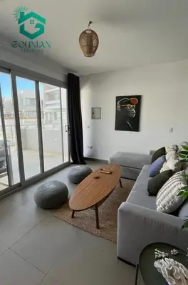 a living room with a couch and a table at Sholan, 1 Bedroom, Ground floor in Hurghada