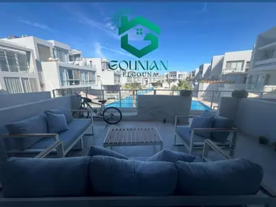 a couch and chairs on a balcony of a building at Sholan, 1 Bedroom, Ground floor in Hurghada