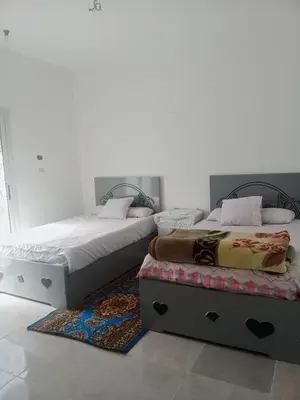 two beds sitting next to each other in a bedroom at elomda in Luxor