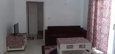 a living room with a couch and a tv at elomda in Luxor
