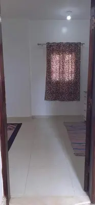 a room with a curtain hanging on a wall at elomda in Luxor