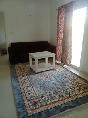 a living room with a white coffee table on a rug at elomda in Luxor