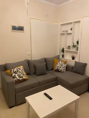 a living room with a couch and a coffee table at Modern Apartment with Direct Pool Access in Aqua Tropical in Hurghada
