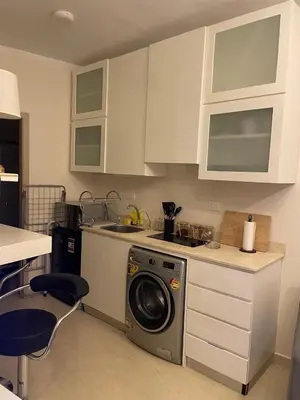 a kitchen with a washing machine on a counter at Modern Apartment with Direct Pool Access in Aqua Tropical in Hurghada