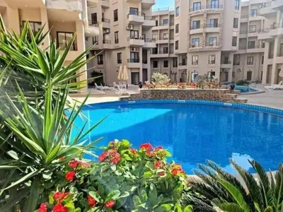a large swimming pool in front of a building at Modern Apartment with Direct Pool Access in Aqua Tropical in Hurghada