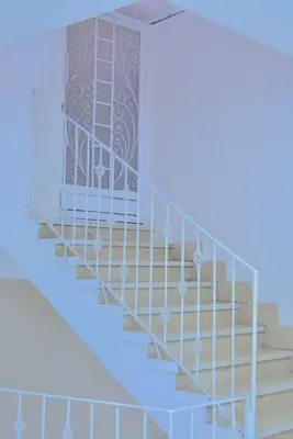a set of stairs in a house with a railing at Jasmin house in ‘Ezbet Abu Ḥabashi