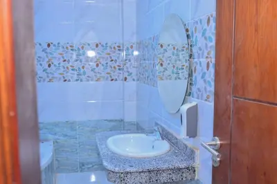 a bathroom with a sink and a mirror at Jasmin house in ‘Ezbet Abu Ḥabashi