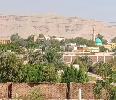 a city with a brick wall and a city with a mosque at Jasmin house in ‘Ezbet Abu Ḥabashi