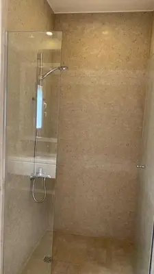 a shower with a glass door in a bathroom at SunShine Joubal view in Hurghada