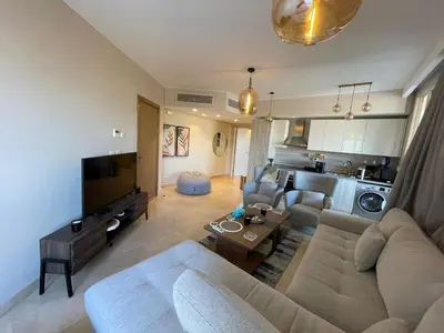 a living room with a couch and a tv at SunShine Mangroovy-M10 in Hurghada