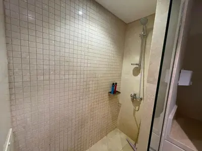 a shower with a glass door in a bathroom at SunShine Mangroovy-M10 in Hurghada