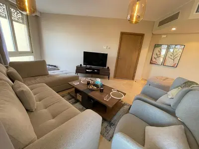 a living room with two couches and a television at SunShine Mangroovy-M10 in Hurghada