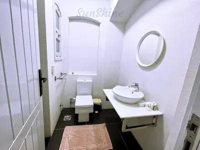a white bathroom with a sink and a mirror at SunShine Y1-0-6 in Hurghada