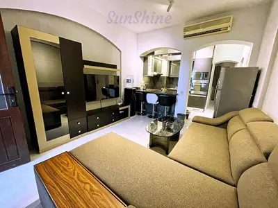 a living room with a couch and a kitchen at SunShine Y1-0-6 in Hurghada