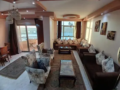 a living room with couches and a table at Monty Homestay in Aswan