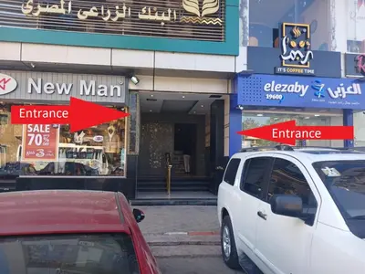 a white van parked in front of a new man entrance at Monty Homestay in Aswan
