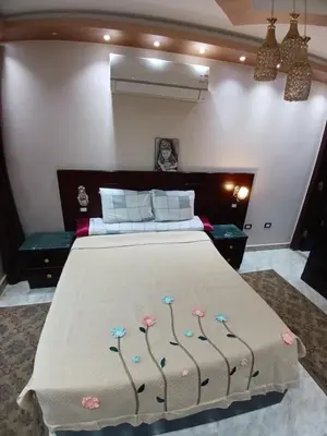 a bedroom with a large bed with flowers on it at Monty Homestay in Aswan