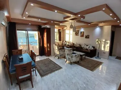 an overhead view of a living room with a table and chairs at Monty Homestay in Aswan