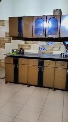 a kitchen with wooden cabinets and a counter top at Nuba in Aswan
