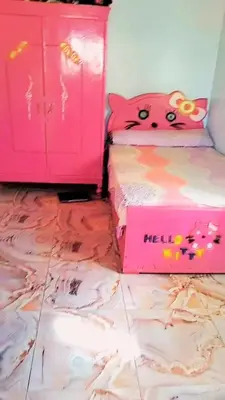 a room with two beds and a pink hello kitty pillow at Nuba in Aswan
