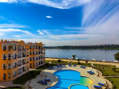 an aerial view of a hotel and a lake at Stunning Nile view Apartment in Luxor