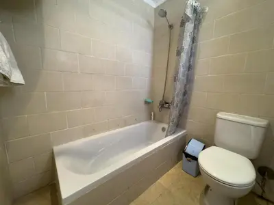 a bathroom with a toilet and a bath tub and a toilet at Stunning Nile view Apartment in Luxor