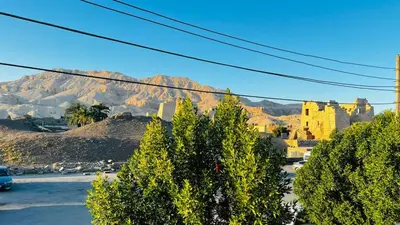 a view of a city with a mountain in the background at Habu House Luxor in Luxor