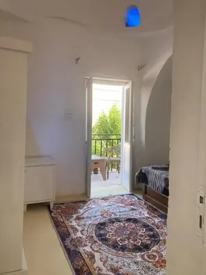 a room with a door leading to a balcony at Habu House Luxor in Luxor