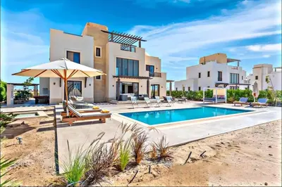 a villa with a swimming pool in front of a house at Luxury villa in gouna in Hurghada