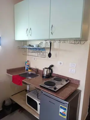 a small kitchen with a stove and a sink at Furnished Chalets for Rent in Cecilia Resort Furnteched, kitchenee, Near Airport in Hurghada