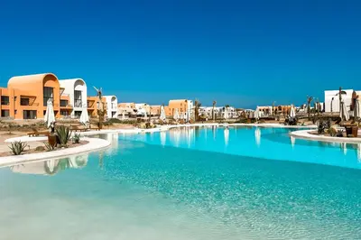 a swimming pool in the middle of a resort at Prim & Pleasing 1BDR Kamaran El Gouna in Hurghada