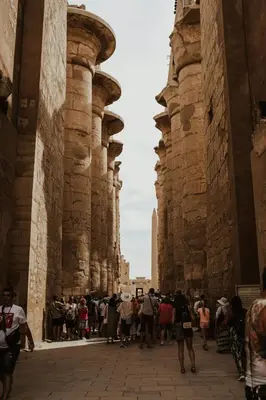 a group of people walking through a row of buildings at 4 Days Nile Cruise from Luxor to Aswan in Luxor