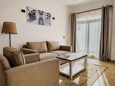 a living room with a couch and a table at Nile view Apartment in Luxor