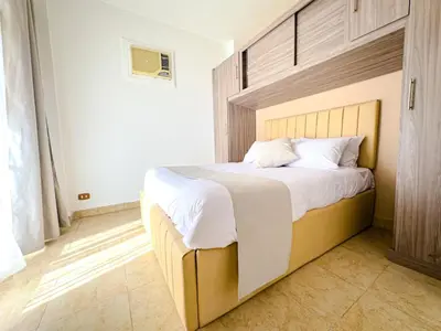 a bedroom with a large bed with white sheets at Nile view Apartment in Luxor