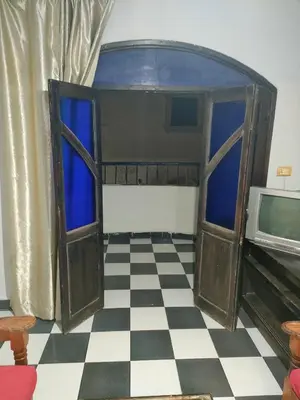 a room with two doors and a checkered floor at Al Dahar apartments Hurghada in Hurghada