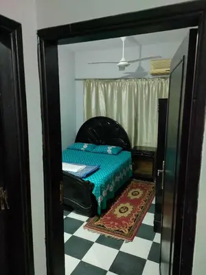 a small bedroom with a bed in a doorway at Al Dahar apartments Hurghada in Hurghada