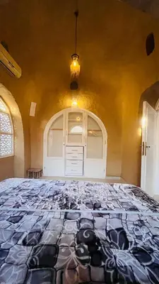 a large bedroom with a large bed in a room at Nubian House in Al Aqālitah