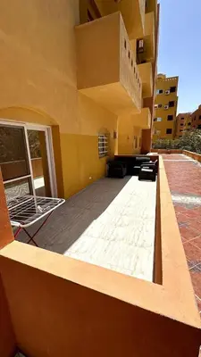 a view of a building with a living room at A 2 BR with pool view Hurghada in Hurghada
